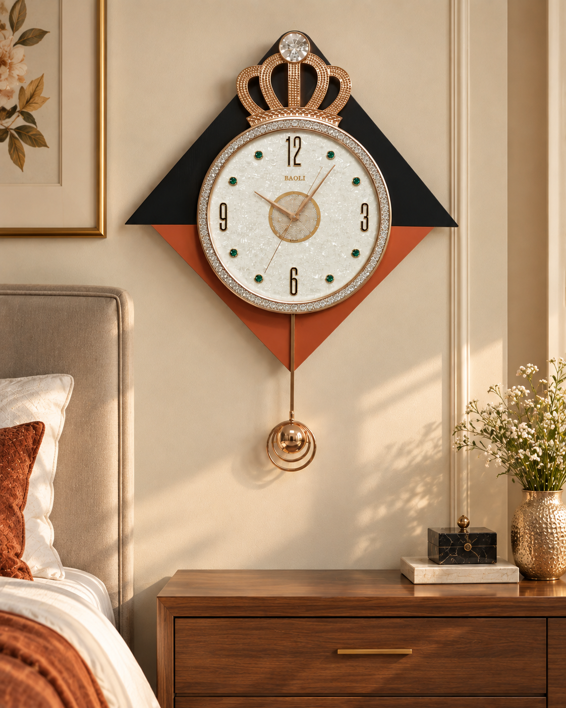 A decorative wall clock with a crown topper and hanging pendulum, mounted above a wooden bedside table in a styled bedroom. The clock has a white face with black numerals, a black and rust-orange geometric background, and gold-toned metal details.