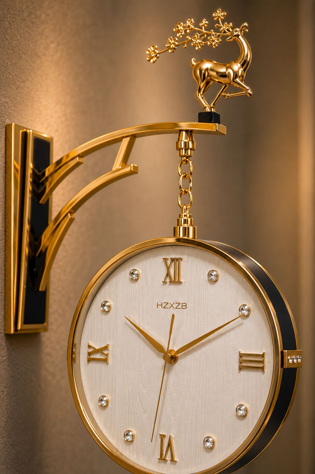 A decorative wall clock with a gold metal bracket and deer finial, featuring a cream dial with Roman numerals and crystal hour markers, mounted on a warm-toned wall.
