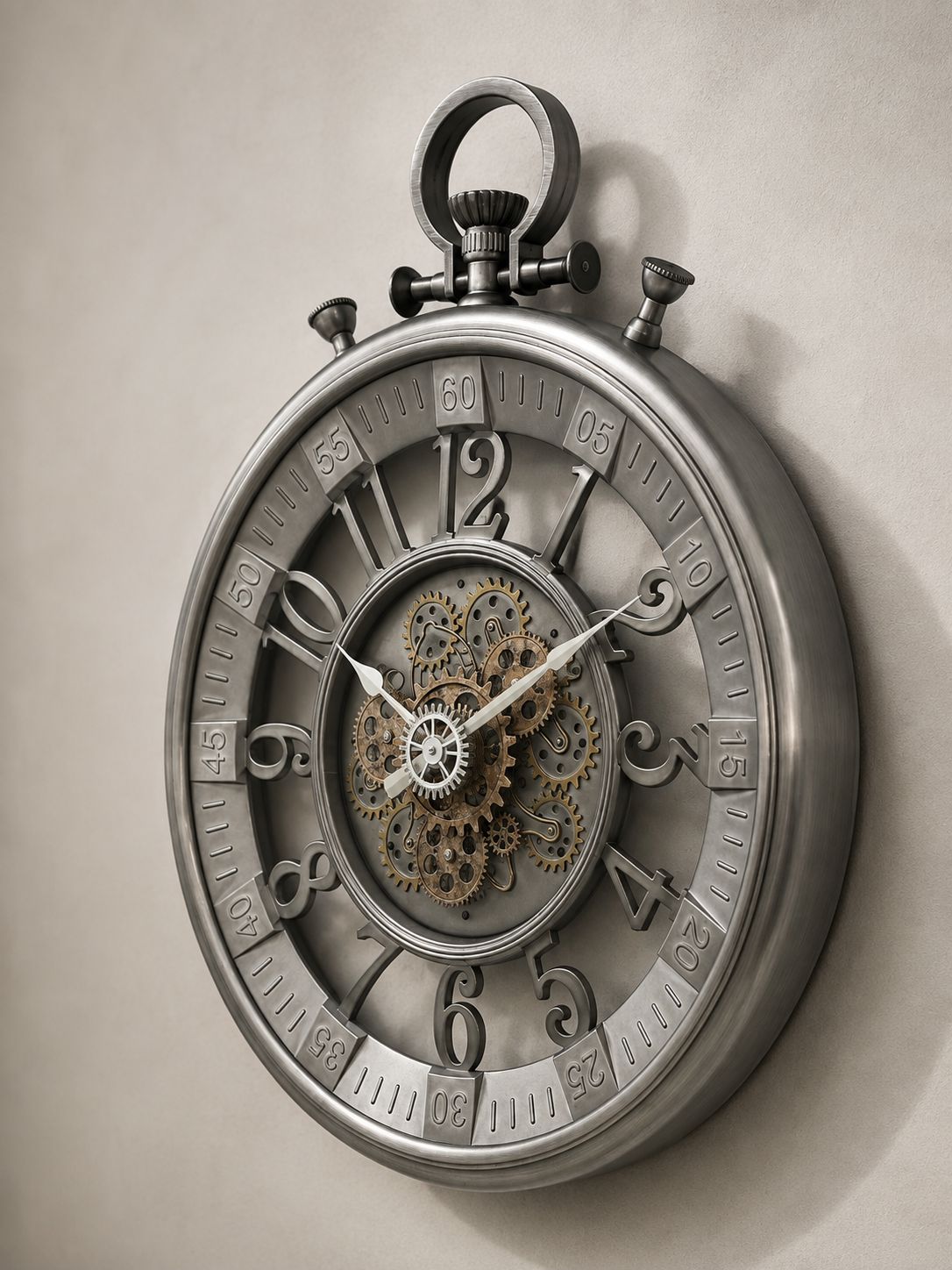 A large decorative wall clock designed like a pocket watch, featuring a metallic silver outer casing, exposed internal gears and cogs at the center, and raised Arabic numerals around the dial, shown against a plain light beige wall.