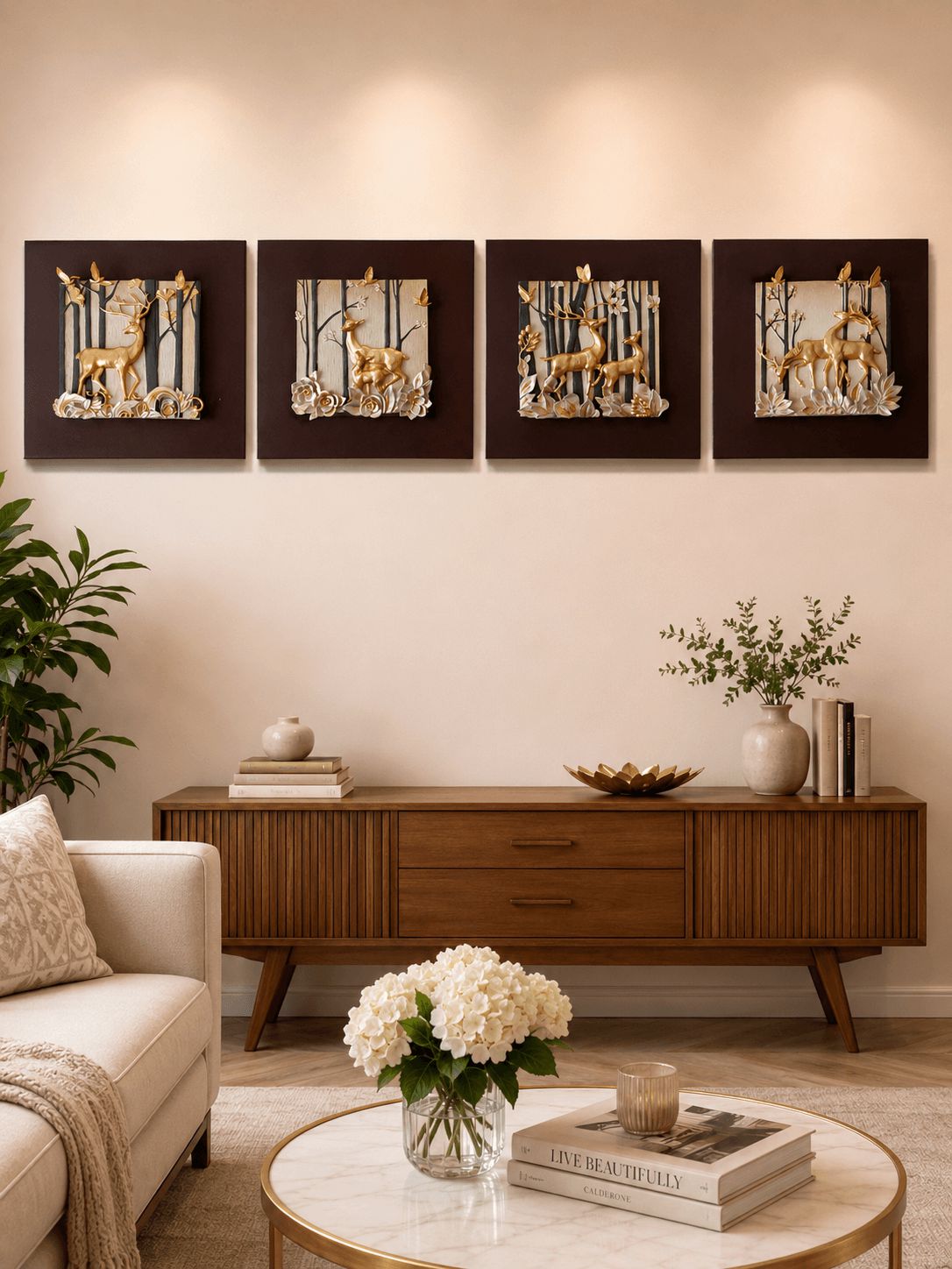 A styled living room scene featuring a four-piece framed wall art set depicting golden deer in a forest. The dark brown frames are mounted on a beige wall above a mid-century modern wooden sideboard with decorative items, a cream sofa, and a marble coffee table in the foreground.