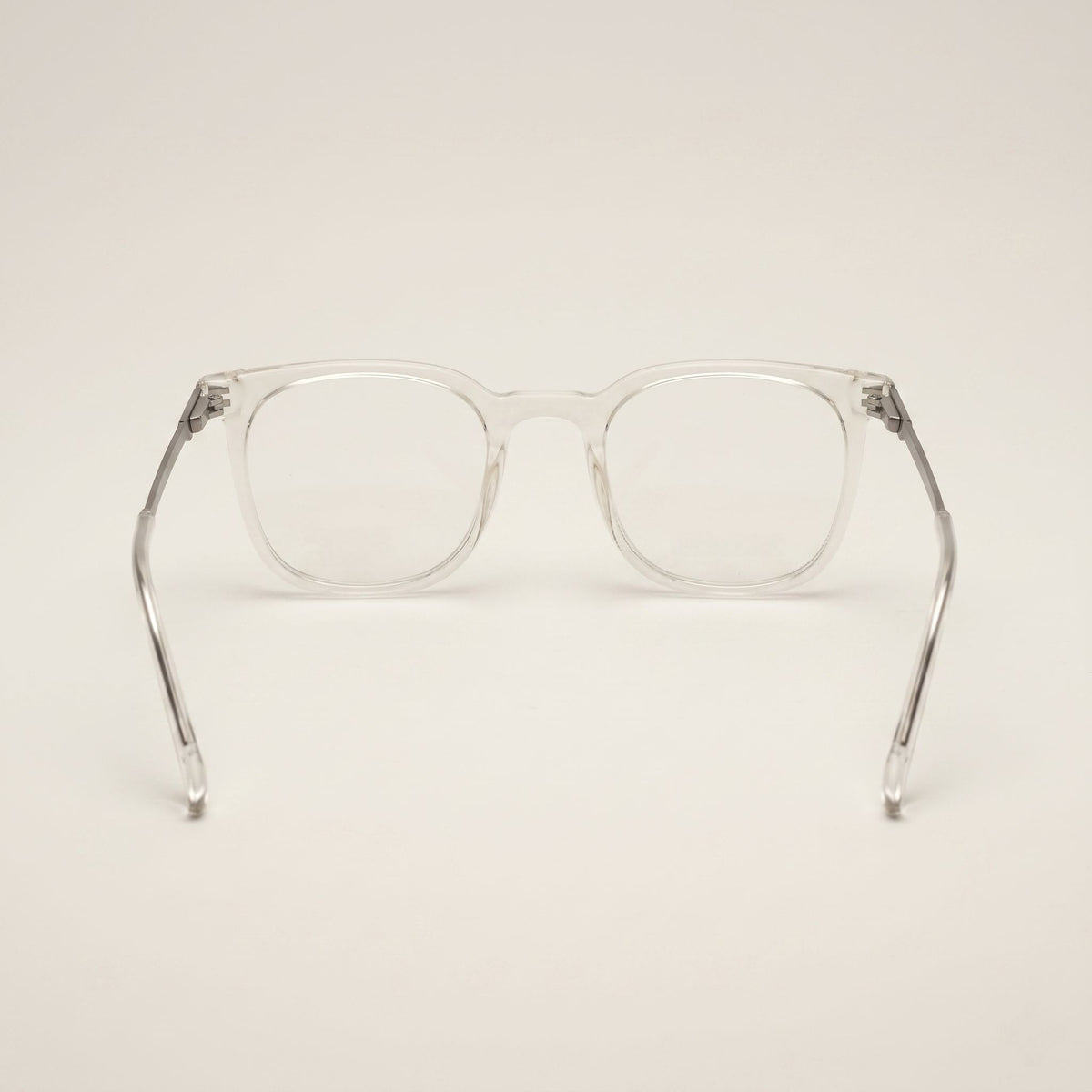 Clear eyeglasses on a light beige background
