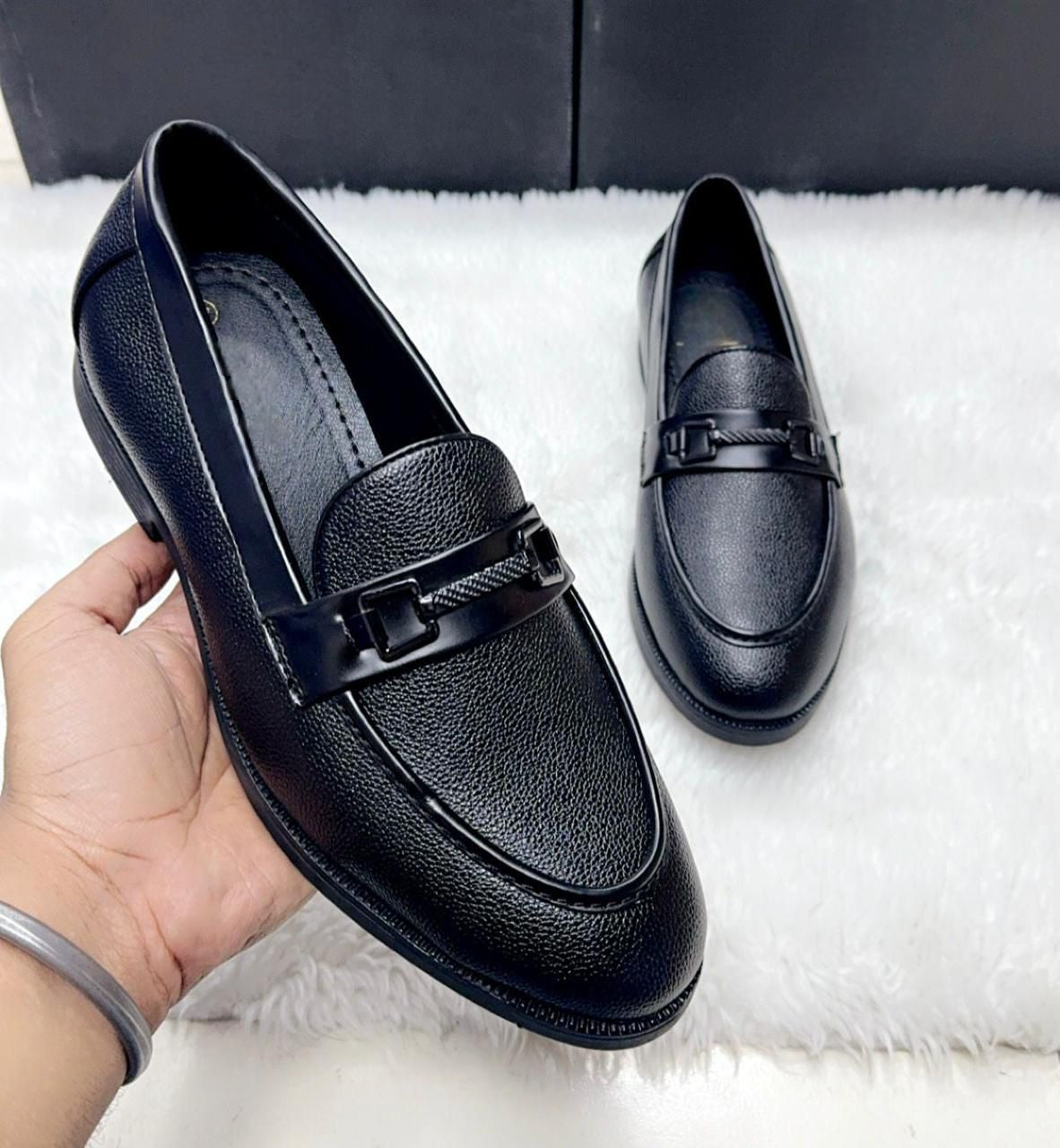 Close-up of Black Tassel Loafer showing the high-quality suede faux leather texture and buckle detail.
