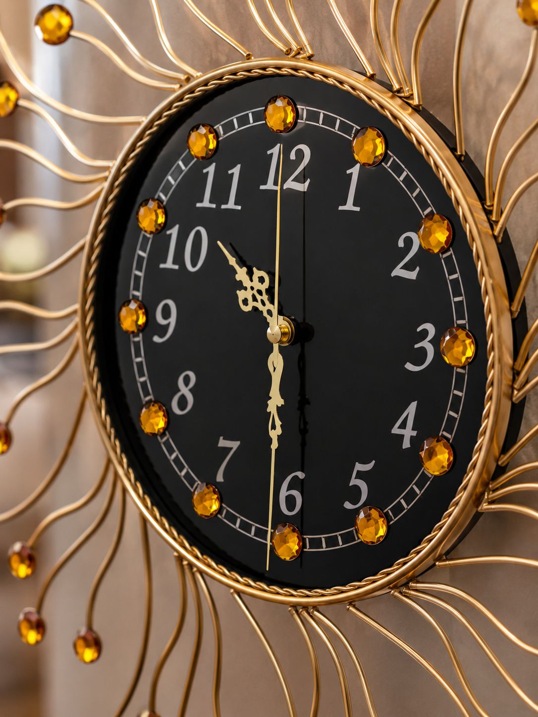 Close-up of premium black dial and amber crystal detailing on luxury wall clock
