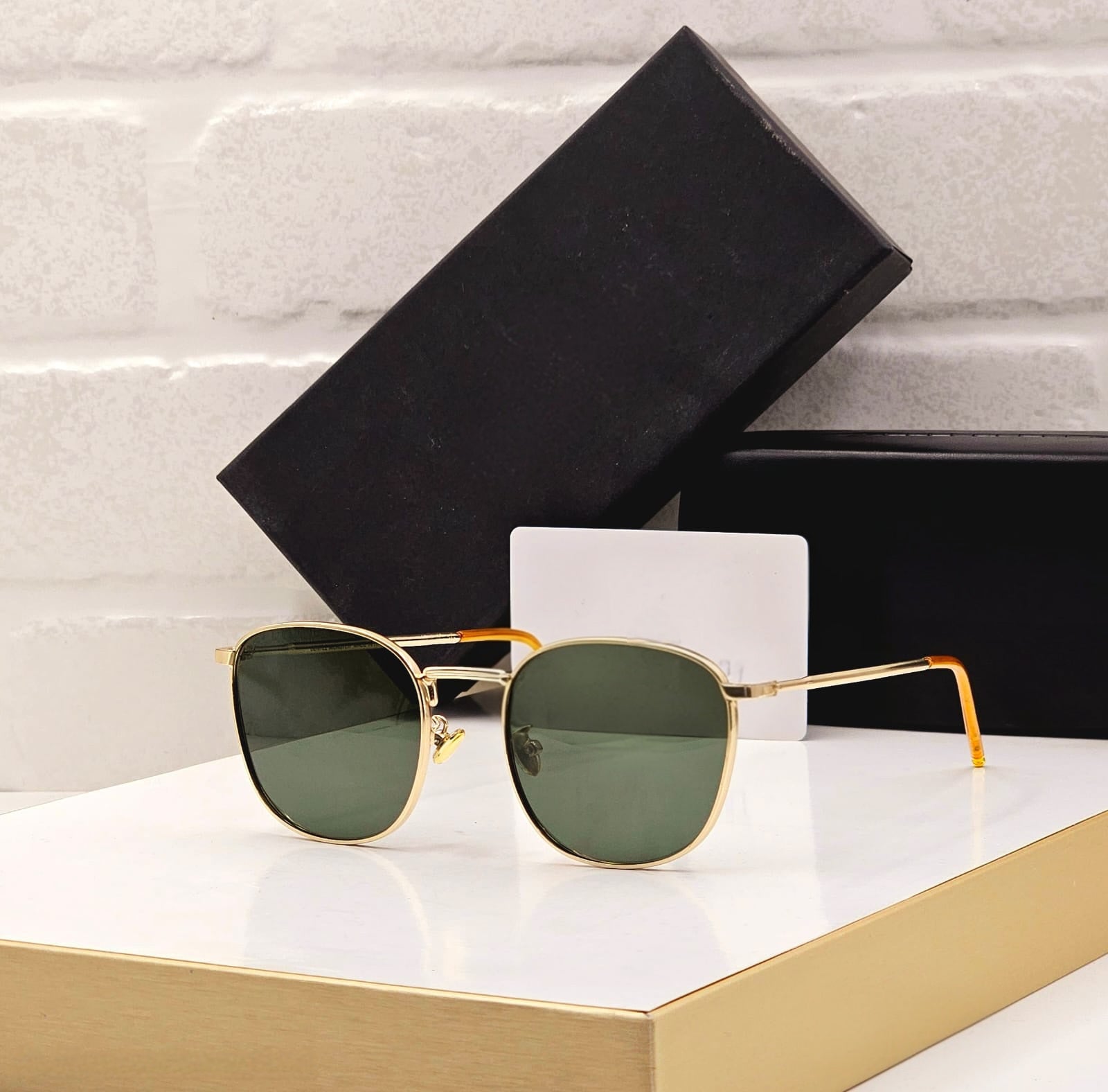 Close-up of the thick acetate frame showing the gold detail on the sunglasses temple.