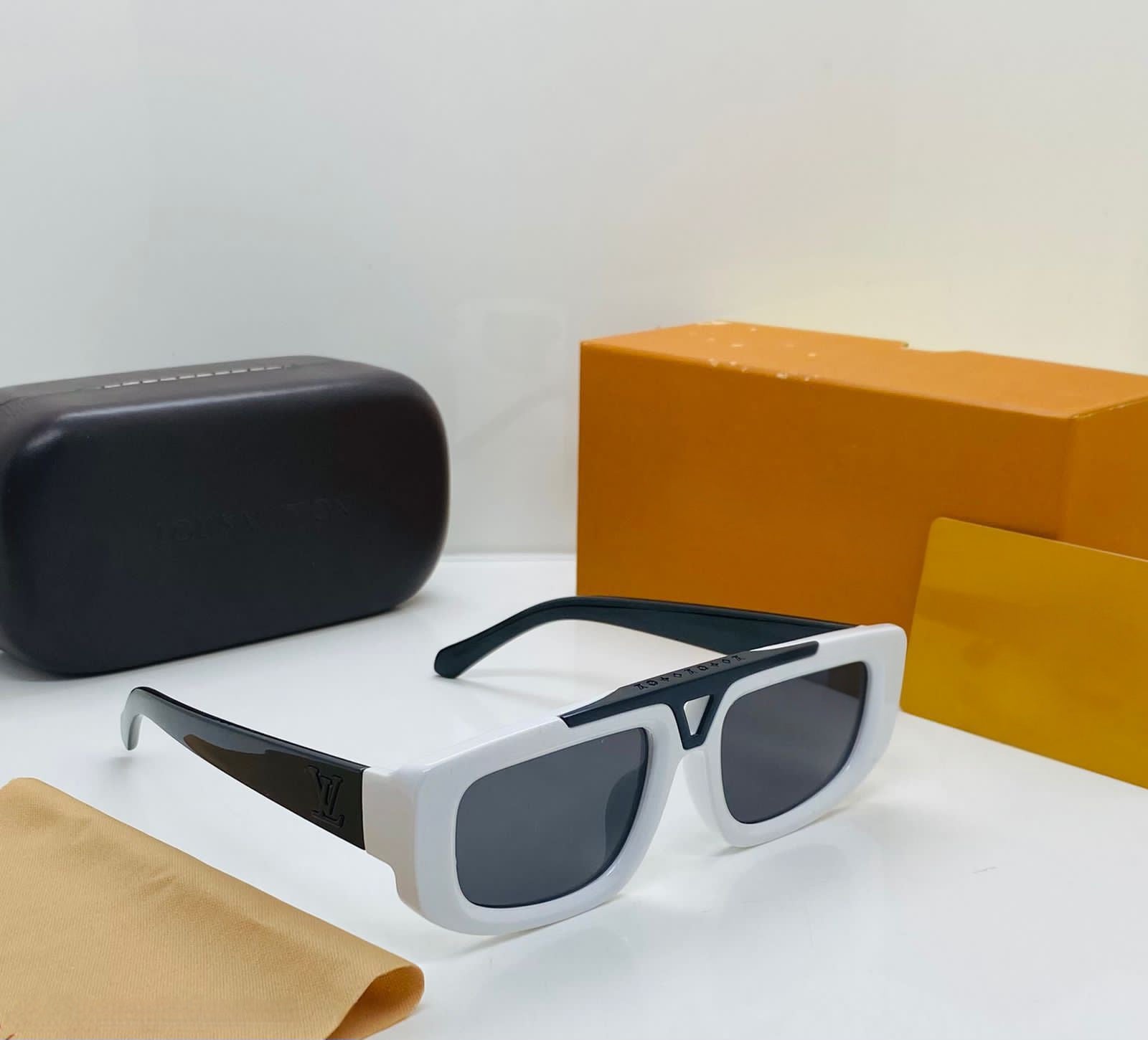 Close-up of the white and black chunky sunglasses showing the texture and the wide temple design.