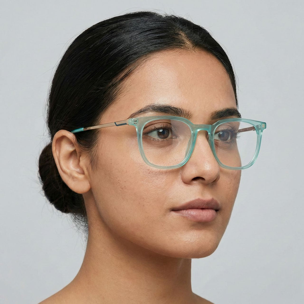 Close-up portrait of woman wearing transparent mint green square eyewear
