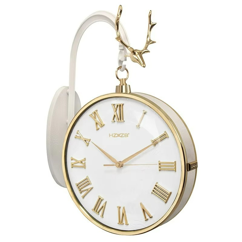 Decorative clock with gold Roman numerals and deer antlers on a white background