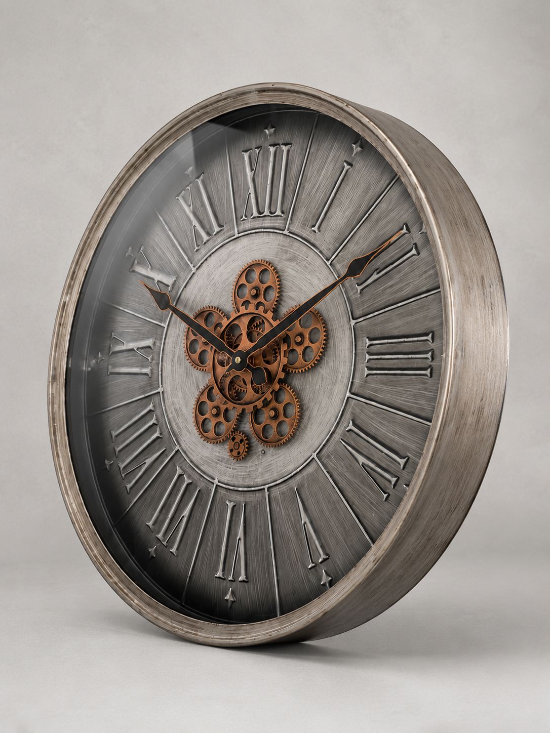 Decorative clock with metallic finish and gear design on a gray background