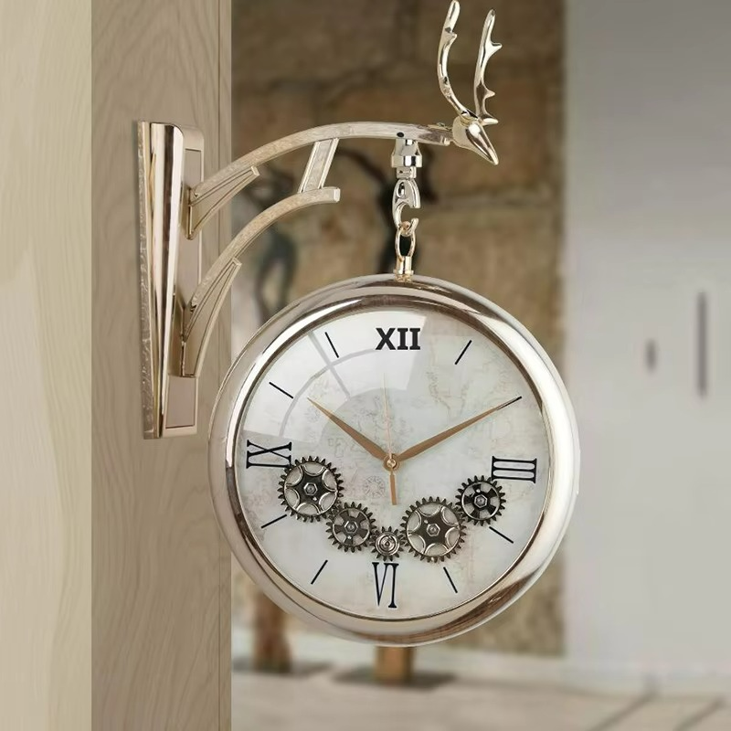 Decorative wall clock with deer antlers on a wooden surface