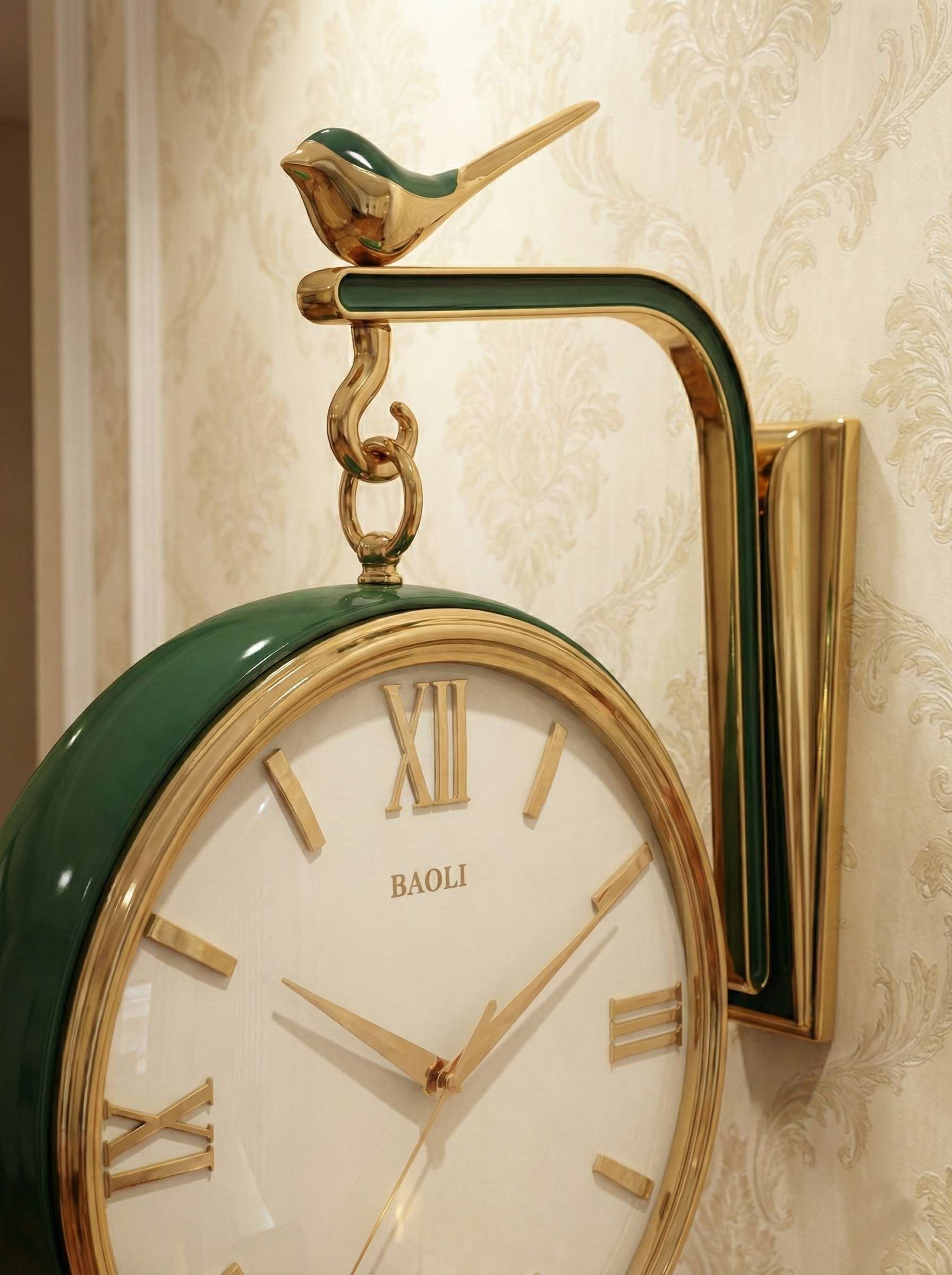 Decorative wall clock with green and gold design on a patterned wall.