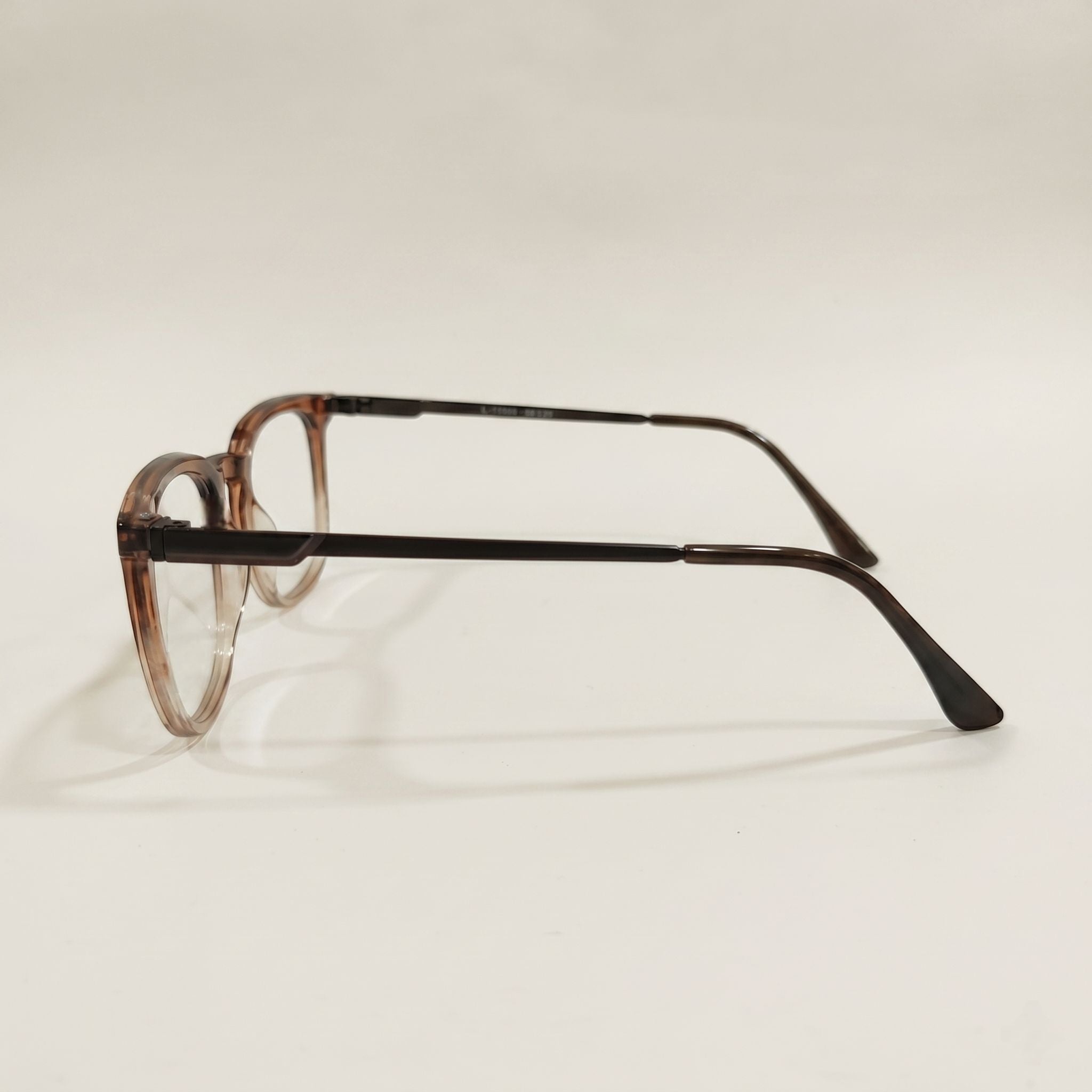 Eyeglasses with a brown frame on a light beige background
