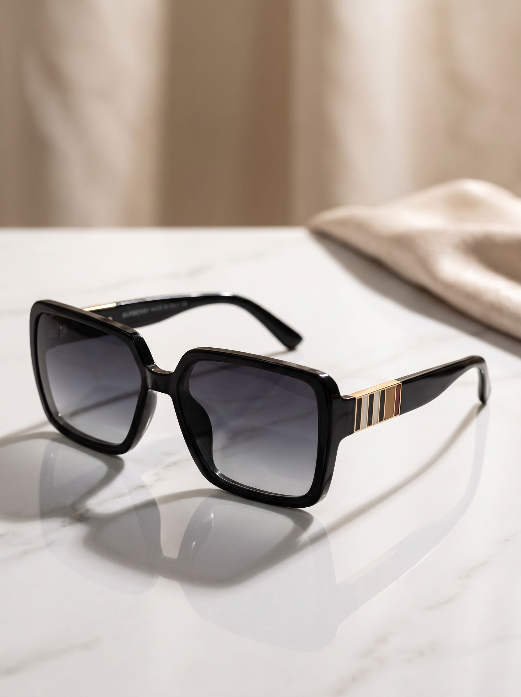 Front angle hero shot of luxury oversized black square sunglasses with gradient lenses