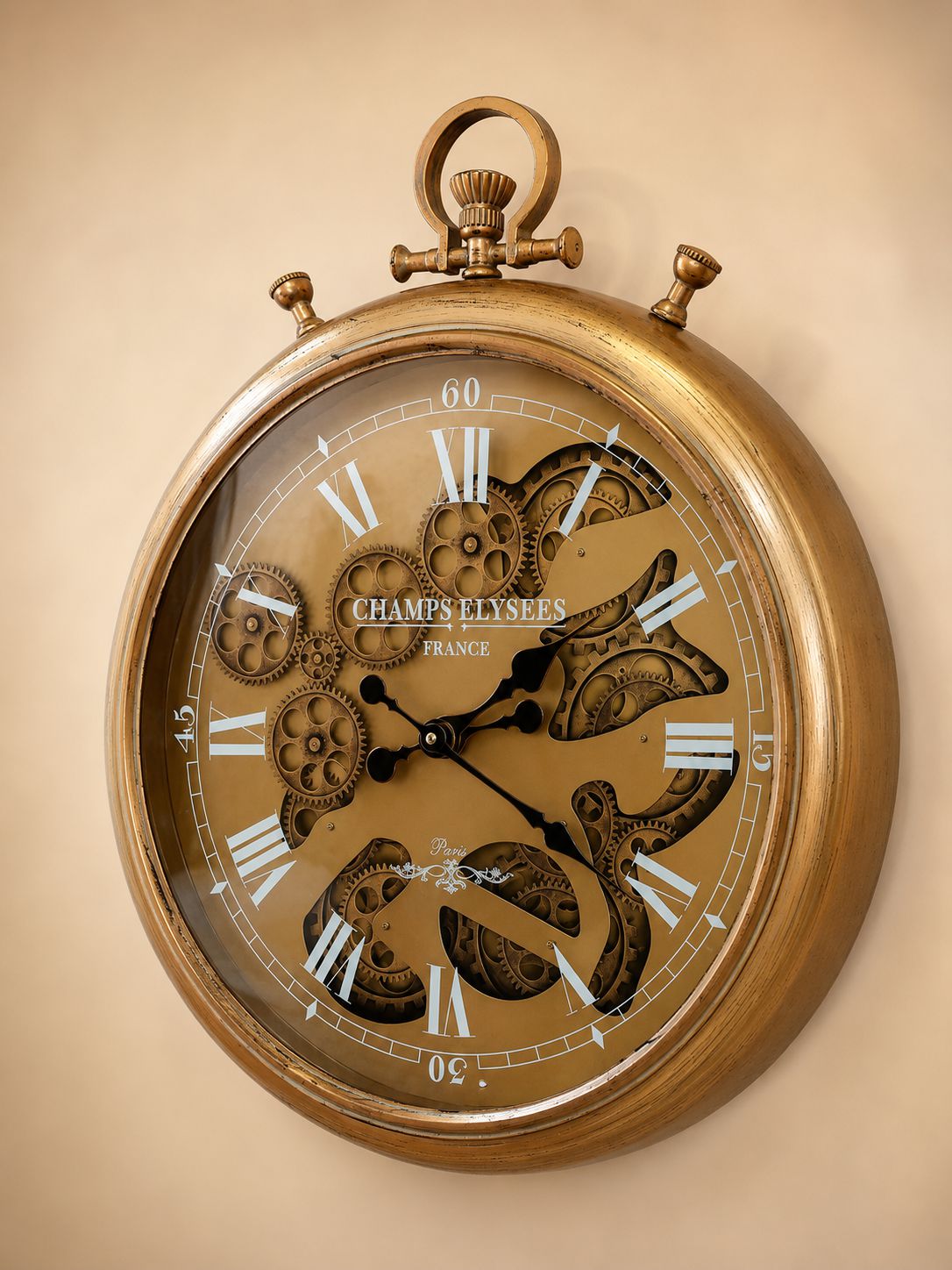 Gold pocket watch clock with visible brand name on a beige background