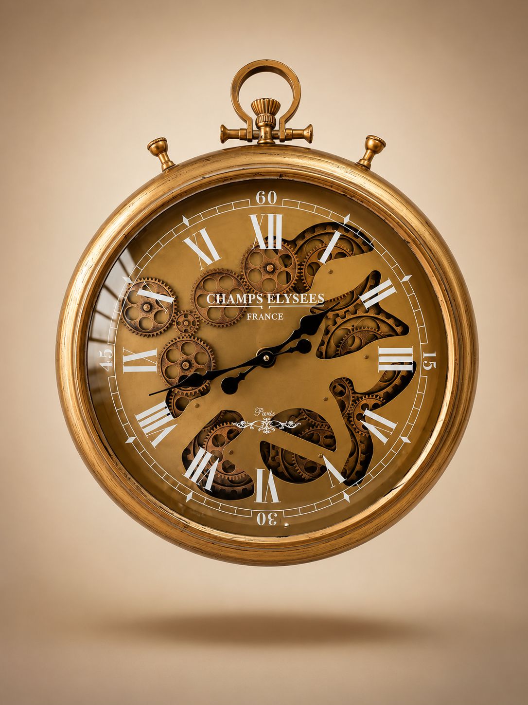 Gold pocket watch with visible gears on a beige background
