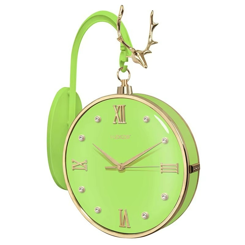 Green clock with gold accents and deer antlers on a white background