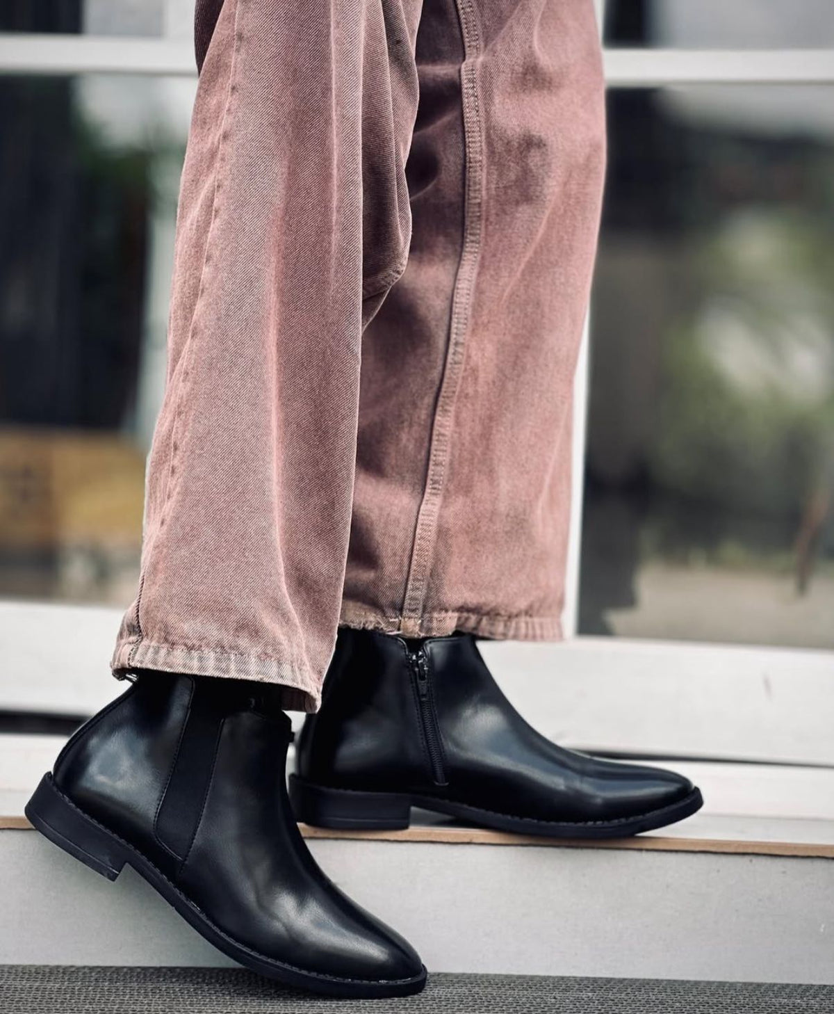 Man wearing FunkyTradition Black Chelsea Boots with jeans, formal casual style