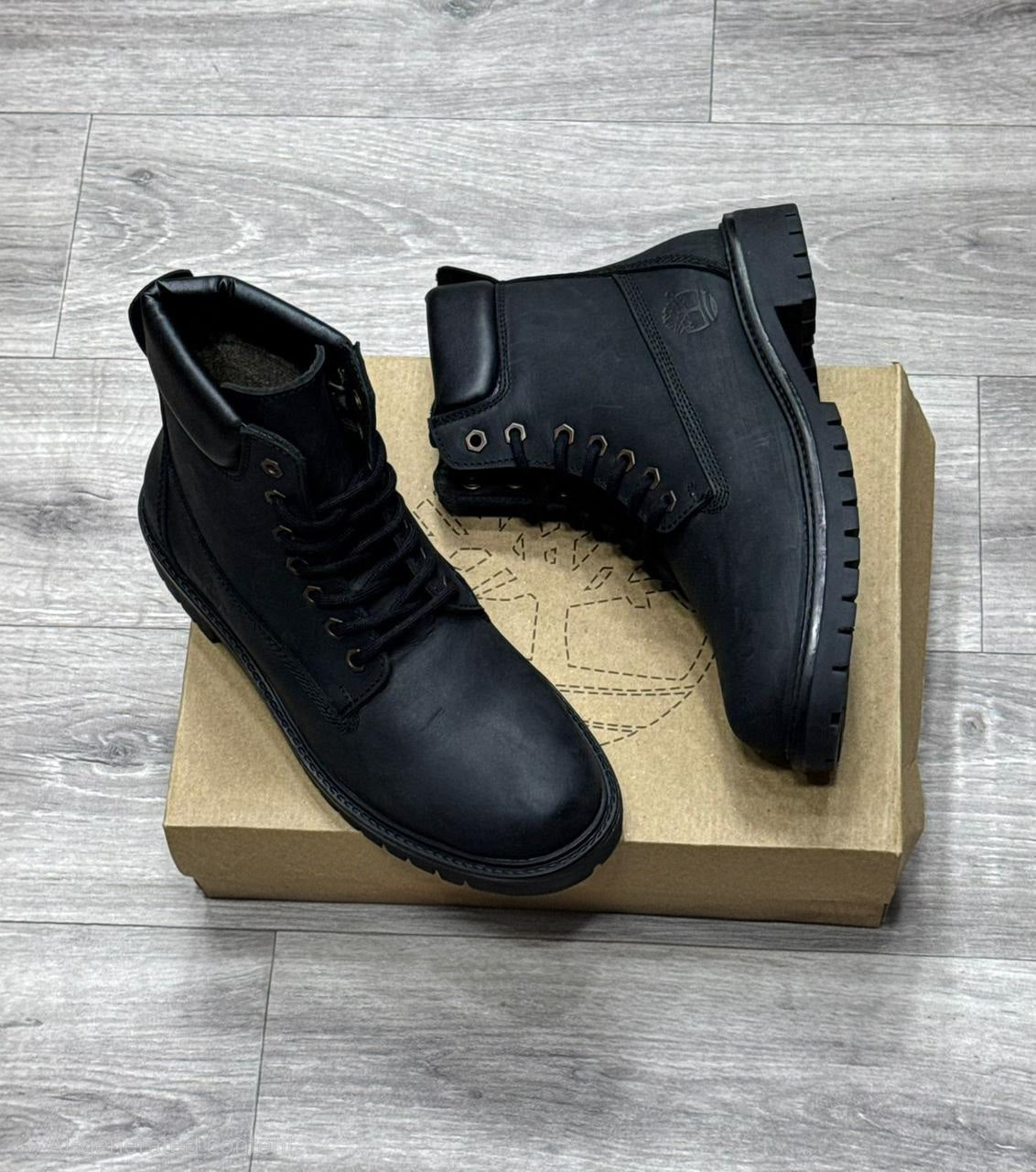 Men's black lace-up boot with durable black TPR sole (side view)