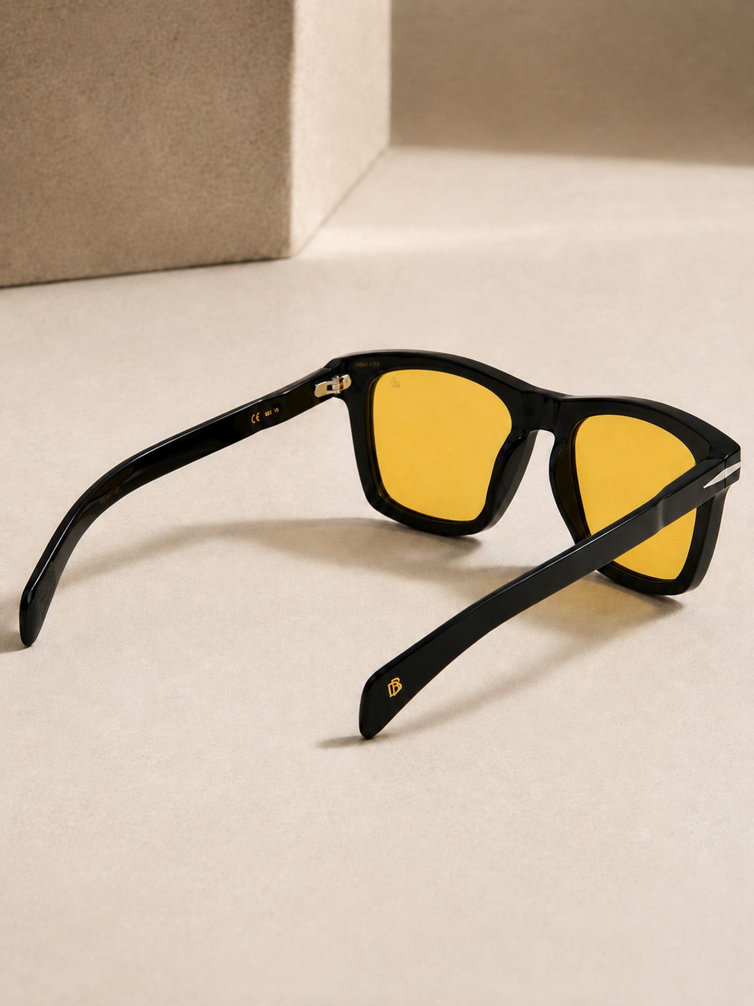 Men's black square sunglasses with yellow lenses and metallic temple detailing — David Beckham inspired style