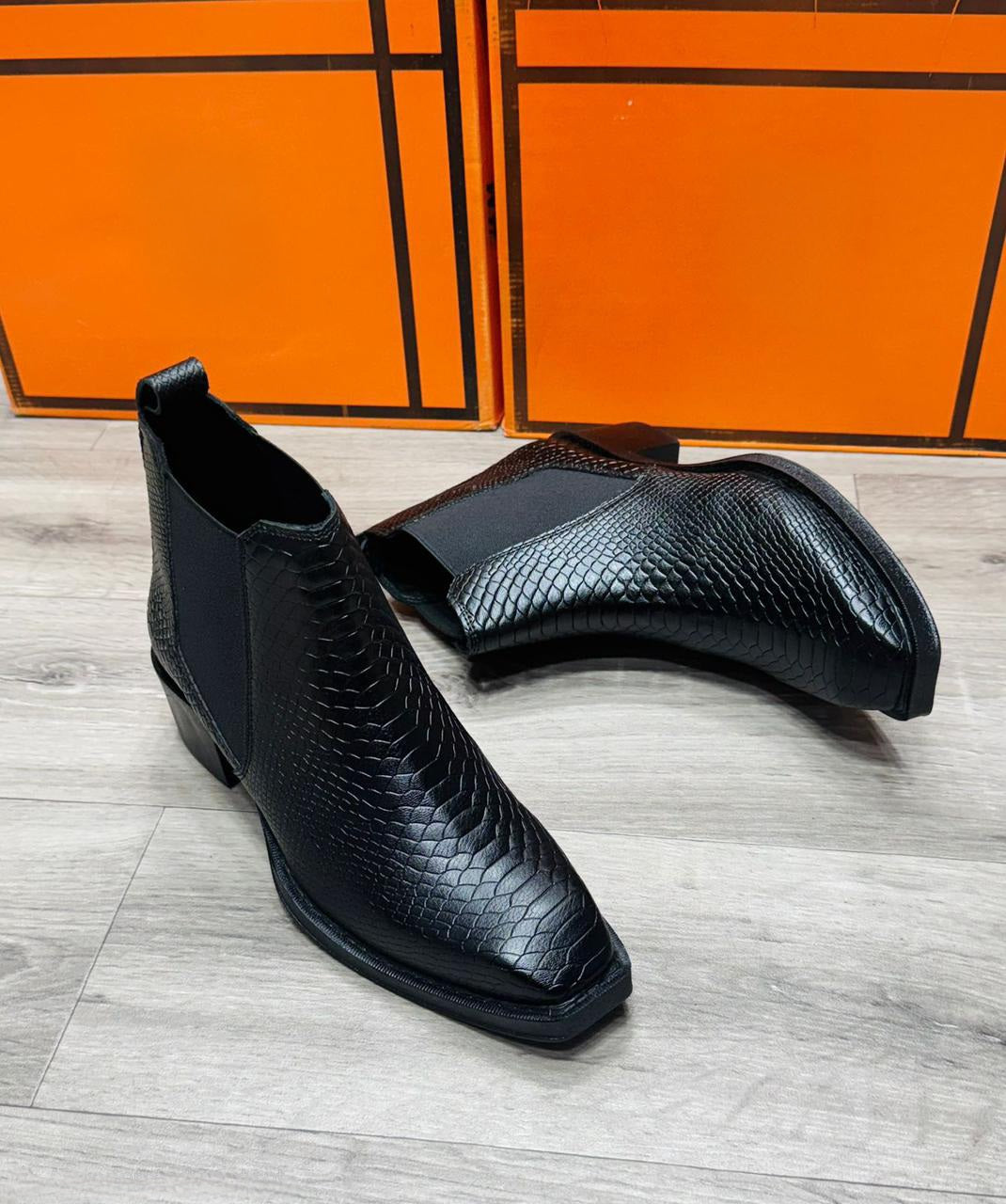 Pair of black ankle-length Chelsea boots, side profile – FunkyTradition