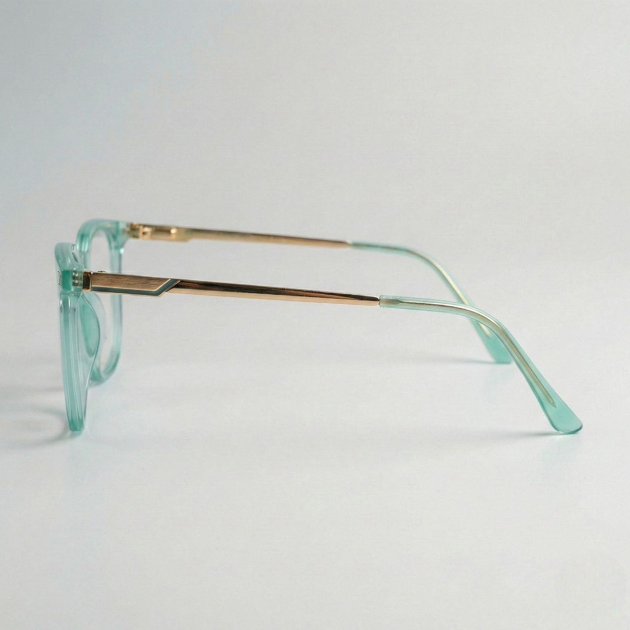 Side profile view of mint green crystal eyeglass frame with gold temples