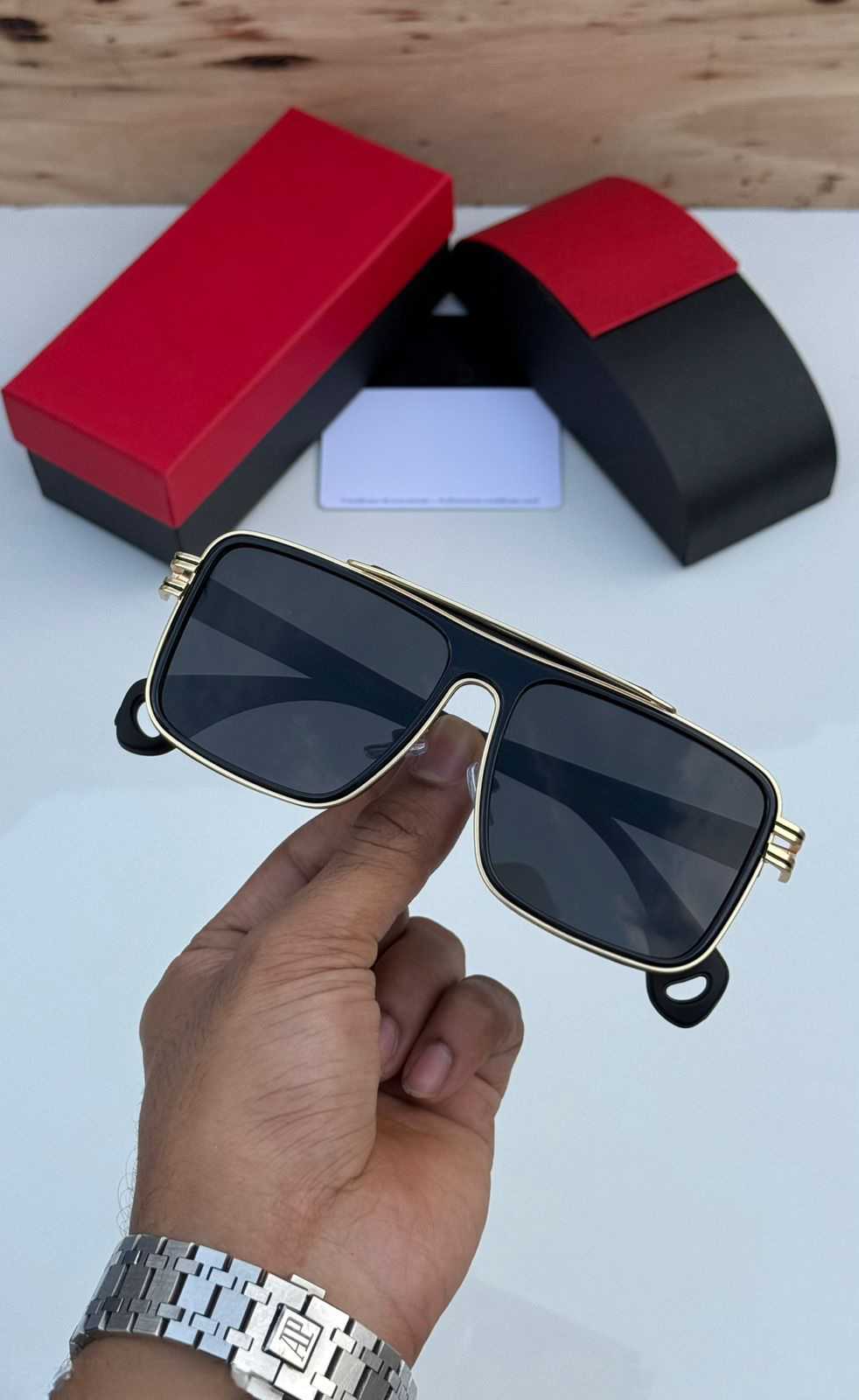 Side view of black and gold square aviator sunglasses showing the gold metal temple detailing.