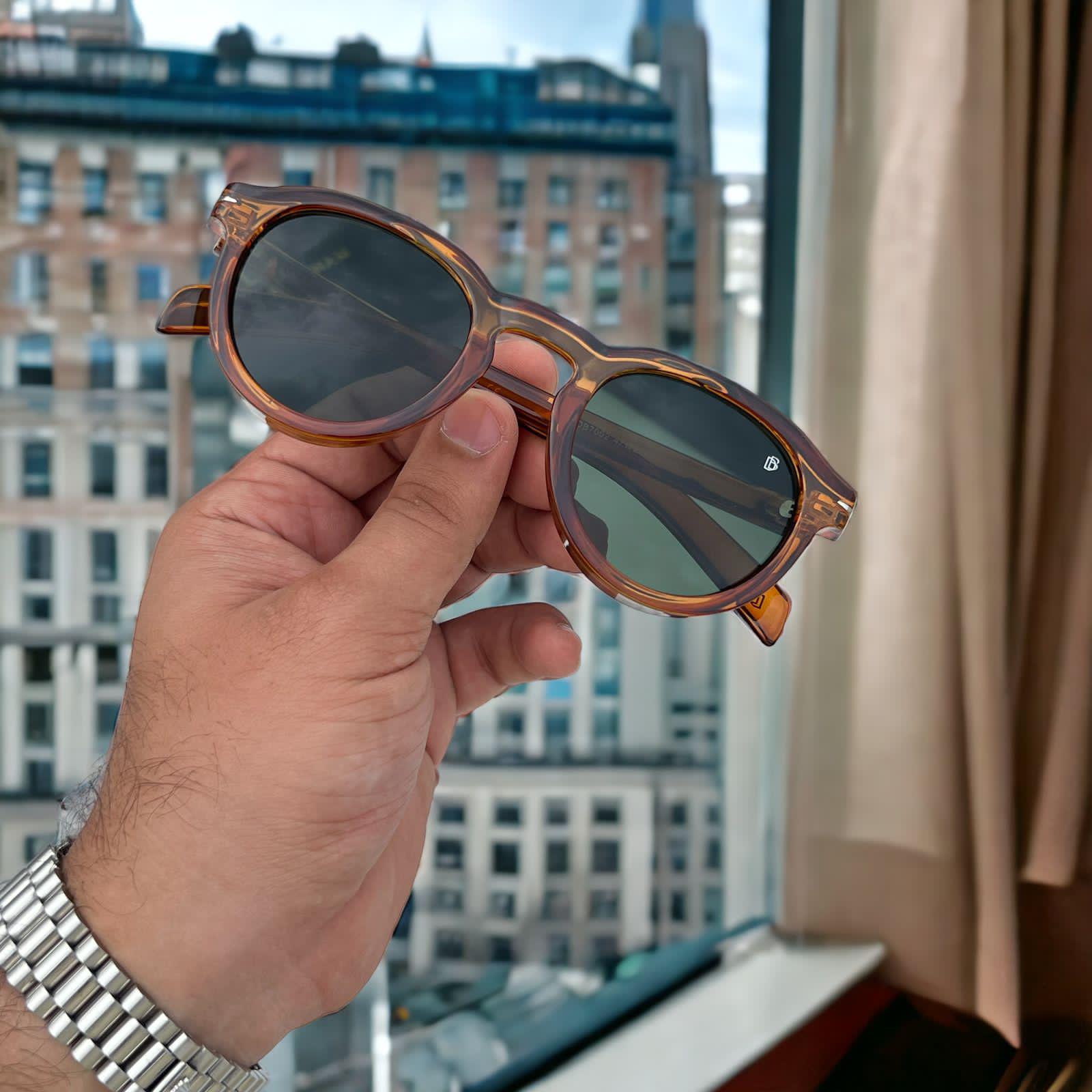 Transparent brown frame sunglasses with green lens