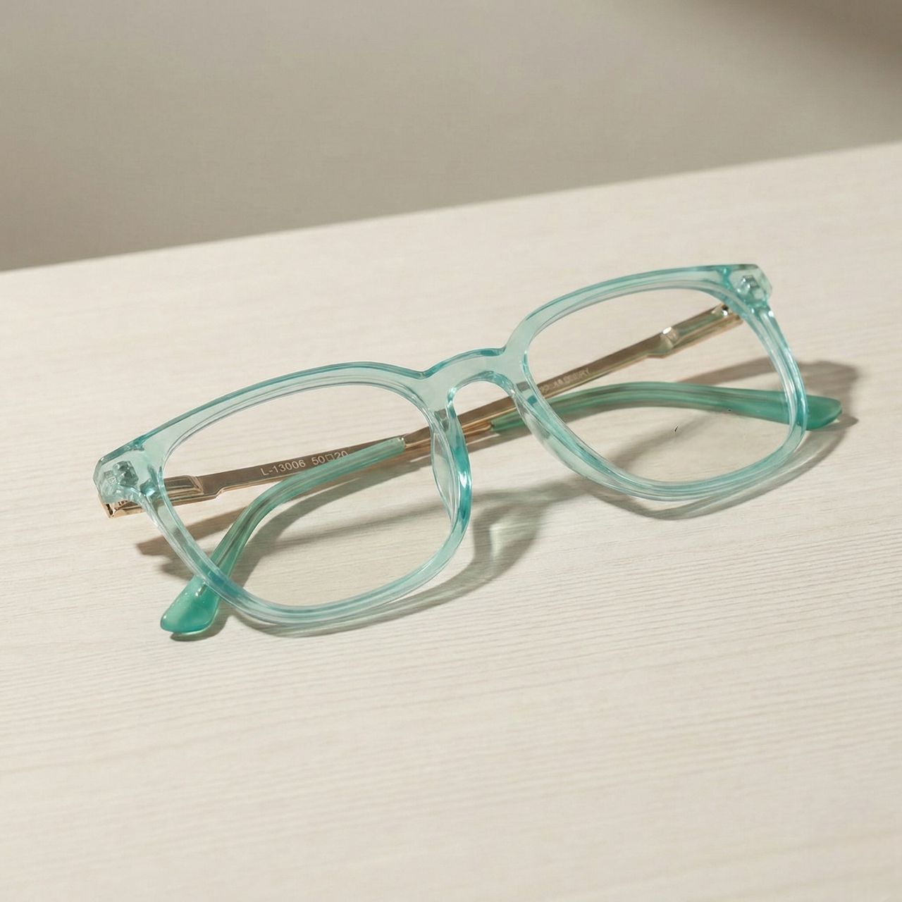 Transparent mint green square eyeglasses with gold metal temples premium eyewear