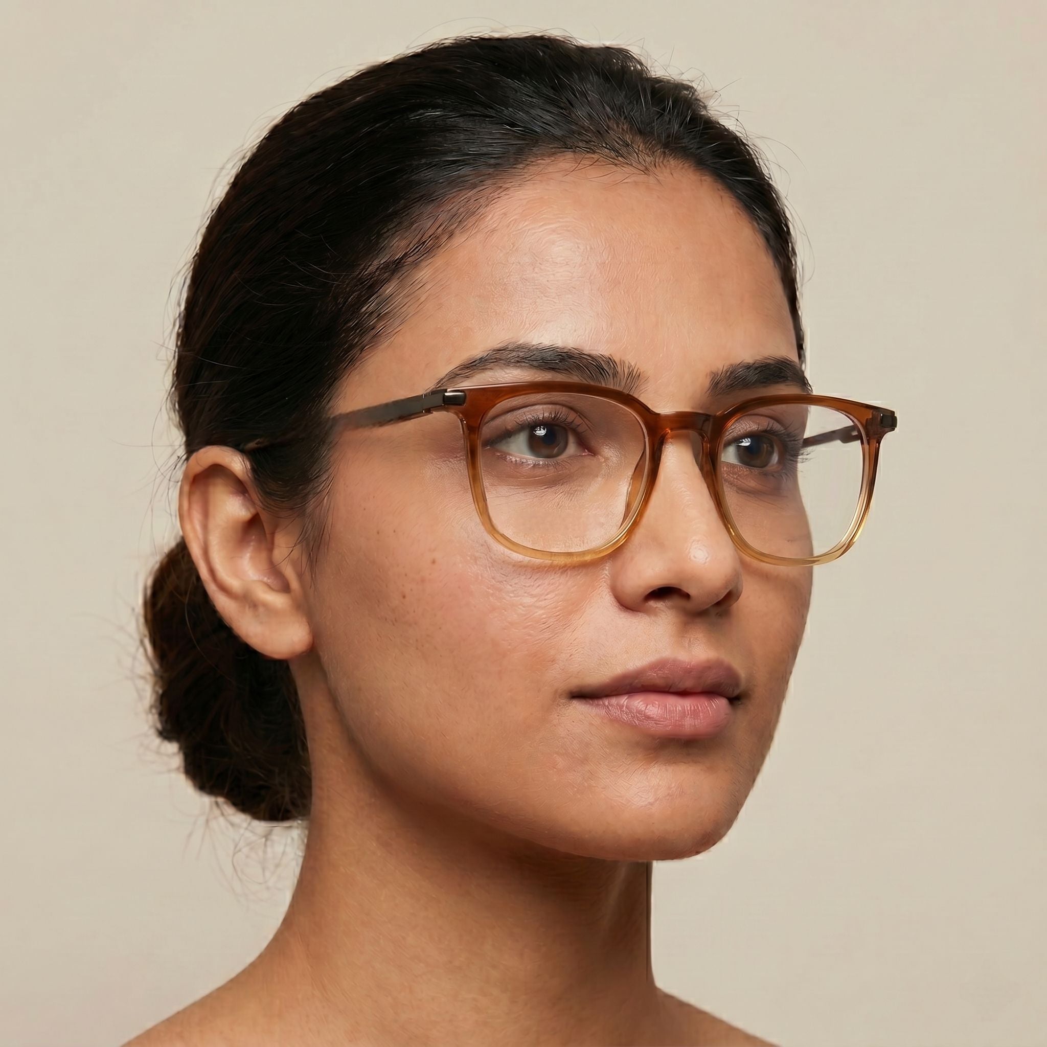 Woman wearing glasses with a neutral background